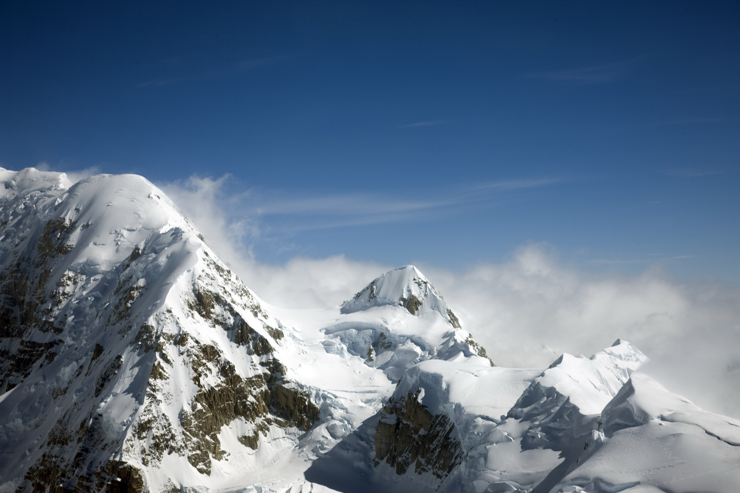 Rugged snow-covered peaks and ridgelines in the Alaska Range